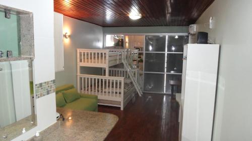 a living room with a refrigerator and a kitchen at Ajuricaba Suítes 7 in Manaus
