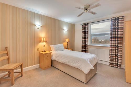 a bedroom with a bed and a window at White Waters Hotel in Llangollen