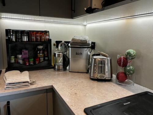 a kitchen counter with a coffee maker and a toaster at Luxury Retreat in Embsay
