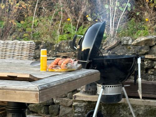 a grill sitting next to a table with food on it at Luxury Retreat in Embsay