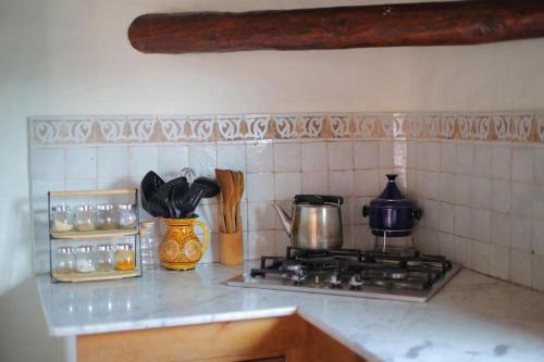 a kitchen counter top with a stove top oven at El Descansillo in Tetouan