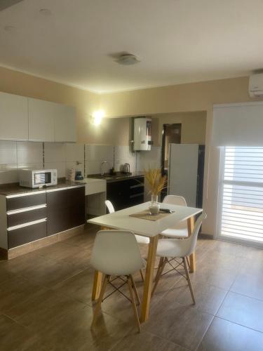 a kitchen with a table and chairs in a room at Caseros 139 in General Alvear