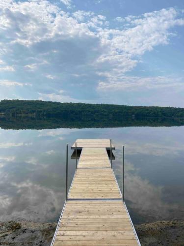 a wooden dock on a body of water at The Luxe Lodge in Algonquin Highlands