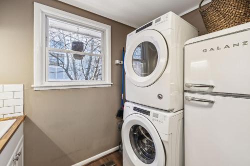 a laundry room with a washer and dryer next to a window at Belmont kings 1 mile to downtown and park free in Nashville