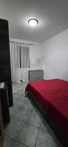 a bedroom with a bed with a red blanket at Bee House in Bosa