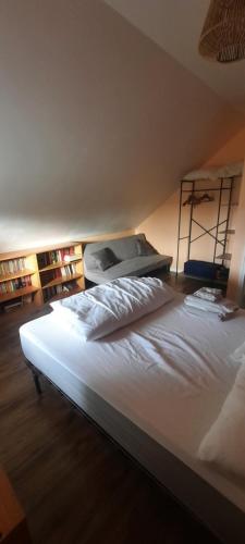 a large bed in a room with a mattress at La petite maison de Chavroches - proche du Pal in Chavroches