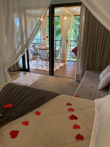 a bedroom with a bed with hearts on it at Pousada L'Amore in Siderópolis