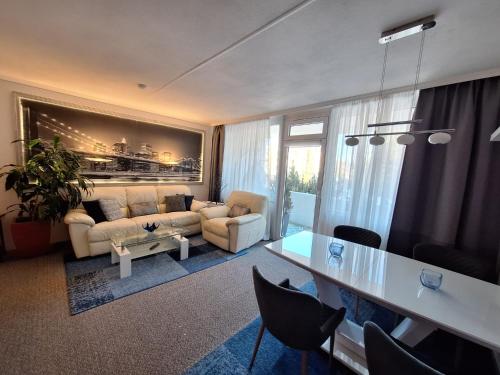 a living room with a couch and a table at Grossdorf Ferienwohnung Waldsuite im Harz in Hahnenklee-Bockswiese