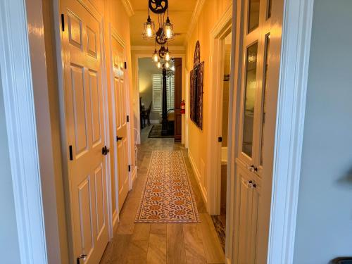 a hallway of a home with a rug on the floor at Bliss On The River in Llano