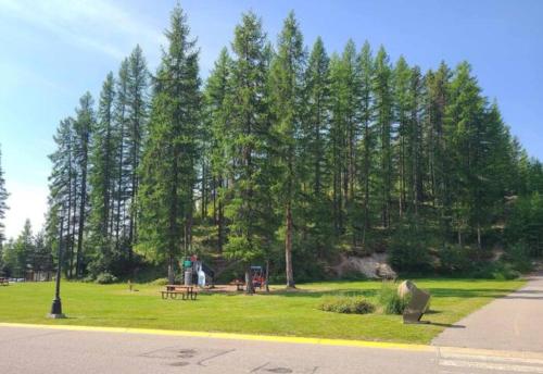 a park with a bench and a picnic table and trees at Stemwinder Duplex Chalet by StayIn in Kimberley
