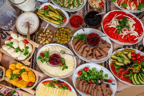 a table with many plates of food on it at Grand Podhale Resort&Spa Zakopane - Jacuzzi - Sauna fińska i Łaźnia parowa - Widok na Tatry in Zakopane