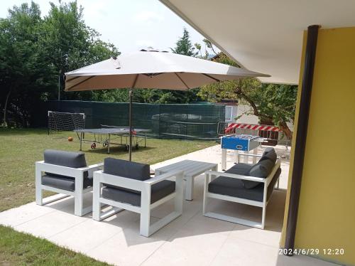 a table and two chairs and an umbrella at Baita Figliezzi in Castello Tesino
