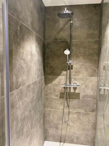 a shower with a glass door in a bathroom at EasyEscape - Martha-Louise in Blankenberge
