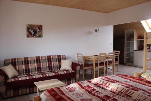 a room with a bed and a couch and a table at Penzion U Červené podkovy in Vlčkov