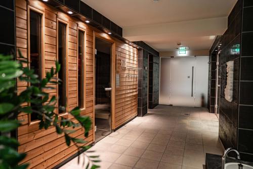 a hallway with wooden walls and a tile floor at Novotel Karlsruhe City in Karlsruhe