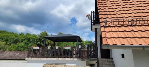 a black umbrella on a fence next to a building at Vila Jovana in Vrdnik