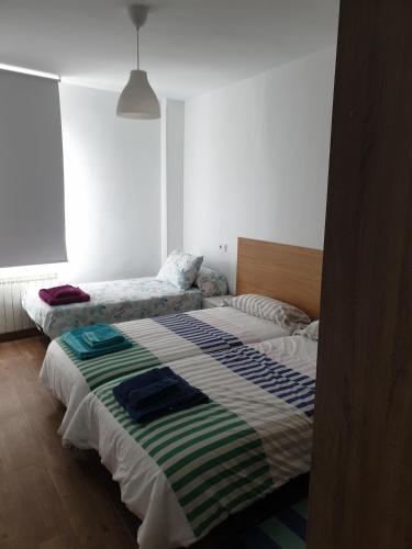 a bedroom with two beds in a room at Tú casa en Aranda in Aranda de Duero