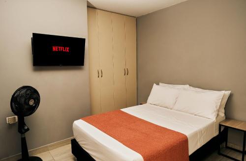 Postel nebo postele na pokoji v ubytování Apartamentos y Loft en Zona Rosa de Laureles