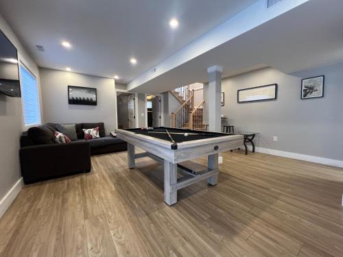 a living room with a pool table in it at The Luxe Lodge in Algonquin Highlands