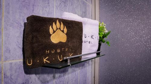 a towel with a peace sign on a towel rack at UKUKU Hostel in Quito