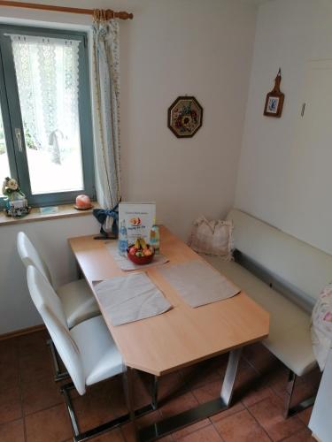 a table and chairs in a room with a window at Ferienwohnung Perschl in Waging am See