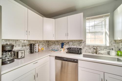 a kitchen with white cabinets and a stainless steel dishwasher at Convenient Tulsa Home - 2 Mi to Downtown! in Tulsa