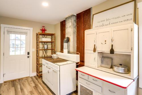 a kitchen with white cabinets and a red counter top at Hike and Relax Blue Ridge Mountain Retreat! in Burnsville
