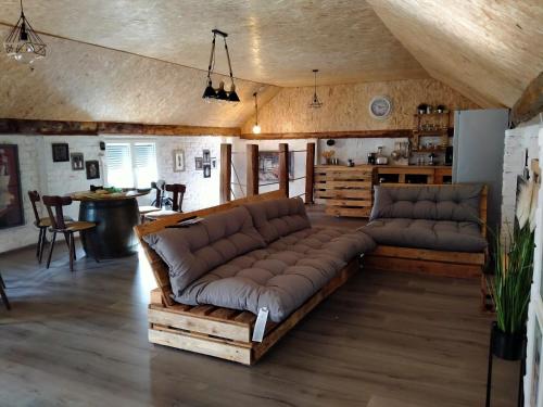 a living room with a large couch and a table at Lika Sunset in Ličko Lešće