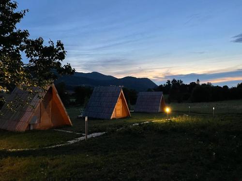 a group of tents in a field at dusk at Lika Sunset in Ličko Lešće