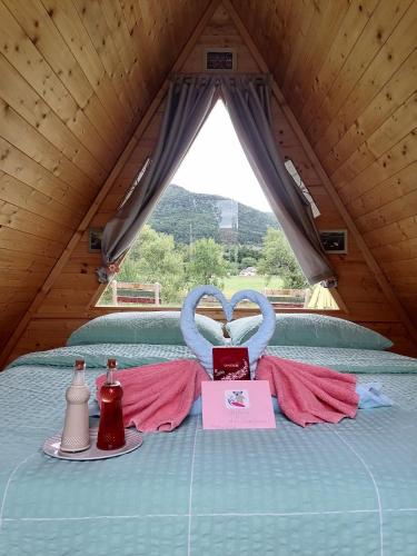 a room with a bed with a table with two utensils at Lika Sunset in Ličko Lešće