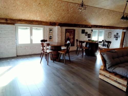 a living room with a couch and a table and chairs at Lika Sunset in Ličko Lešće