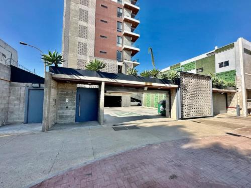 a building with a blue door in a parking lot at Dowtown 1 BR Suite in Av Revolucion Tijuana in Tijuana
