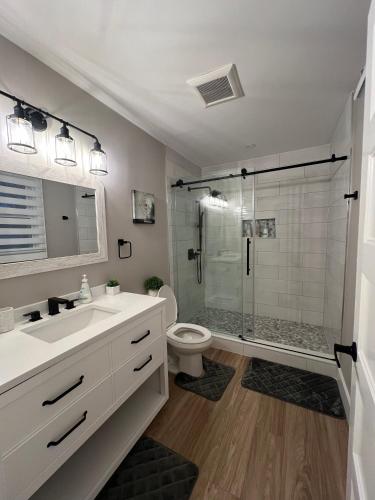 a bathroom with a shower and a sink and a toilet at The Luxe Lodge in Algonquin Highlands