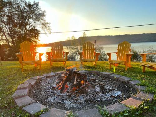 a fire pit with chairs and a table and afire at The Luxe Lodge in Algonquin Highlands