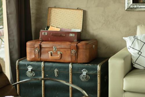 a pile of suitcases stacked on top of each other at Hôtel Le Collier in Antibes