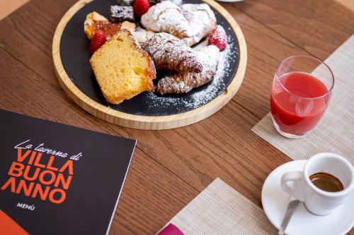 a table with a plate of food and a cup of coffee at Relais Villa Buonanno in Cercola