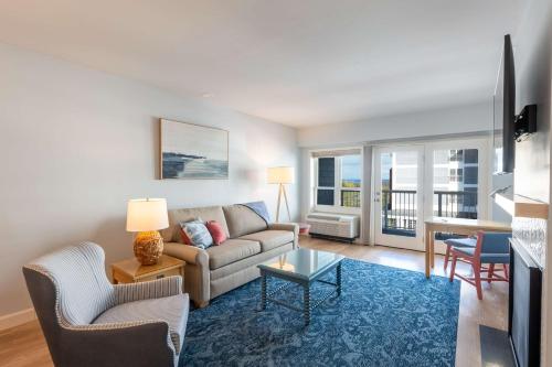 a living room with a couch and a table at Bluenose Inn - Bar Harbor Hotel in Bar Harbor
