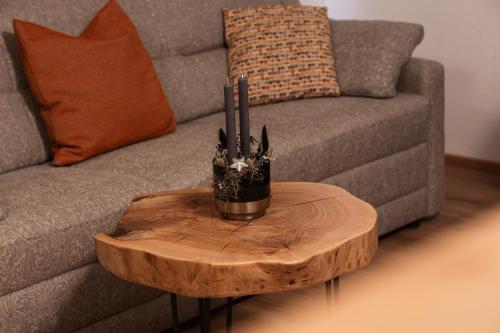a wooden coffee table in front of a couch at Ella's in Fusch an der Glocknerstraße