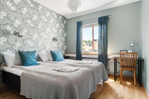 a bedroom with a large bed with blue pillows at Best Western Uppsala in Uppsala