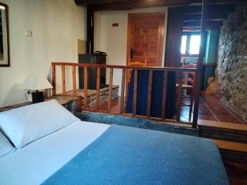 a bedroom with a bed and a balcony at Casa Juez in Ascaso