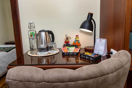 a table with a lamp and a table with a chair at Friends Hotel & Rooftop - Historic Center & Museums in Quito