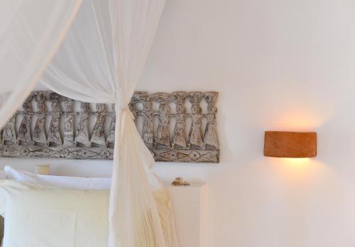 a bedroom with a white curtain and a window at Spinguera Ecolodge in Espingueira