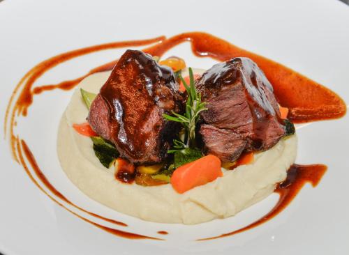 a plate of food with meat and vegetables on it at VILLA NAJ in Termeno