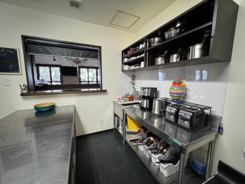 a kitchen with a counter and a counter top at Bears Den Mountain Lodge in Hakuba