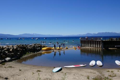 a group of people in the water at a beach at Firelite Lodge in Tahoe Vista