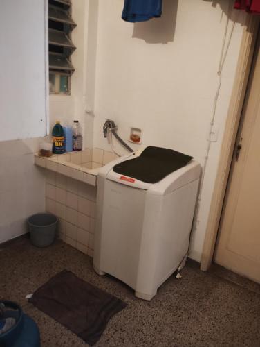 a small kitchen with a sink and a toilet at Vagas Carnaval AP no Centro de BH in Belo Horizonte