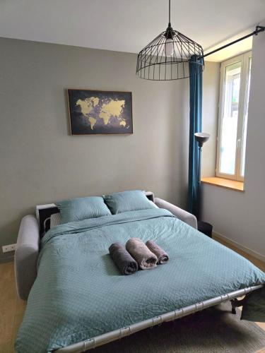 a bedroom with a bed with two pillows on it at Studio du Pont Tournant in Cherbourg en Cotentin