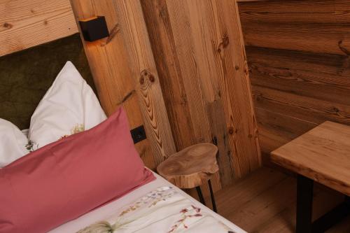 a bedroom with a bed and a table and a chair at Ella's in Fusch an der Glocknerstraße