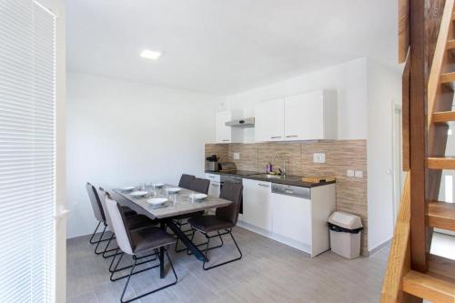 a kitchen with a table and chairs in a room at Apartma Zala in Brežice