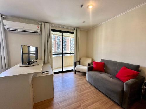 a living room with a couch and a television at The Special Residence Flat - UH1908 in Sao Paulo